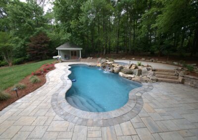 Free form pool with raised platform and hottub